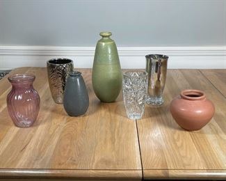 (7pc) ROWE POTTERY & OTHER VASES | A group of decorative vases, including: a Rowe Pottery Works (RPW) brown pottery vase, an RPW gray vase, and the tallest an RPW green pottery vase (h. 13-1/2 in.), each marked / impressed "RPW" on the bottom; plus a cut glass vase, an amethyst glass vase, a silvered glass vase, and a silver-tone vase with flower motif 