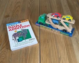 (2pc) CHILDREN'S ITEMS | Both new and unopened, including a Melissa & Doug Classic Toy Car Carrier with four brightly colored wooden cars, and a set of four Kumon workbooks for ages 4, 5, 6 