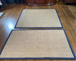 PAIR SAFAVIEH CARPETS | Woven rush carpets, each with navy blue canvas borders, including a 6 ft. x 5 ft. 10 in., and a smaller rug 6 ft. x 4 ft., both with label to under side