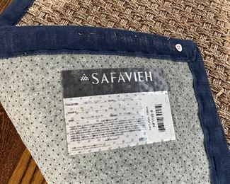 PAIR SAFAVIEH CARPETS | Woven rush carpets, each with navy blue canvas borders, including a 6 ft. x 5 ft. 10 in., and a smaller rug 6 ft. x 4 ft., both with label to under side