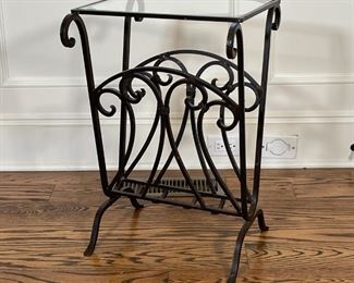 GLASS TOP MAGAZINE RACK TABLE | Wrought iron frame with scroll decorations and a glass top; h. 24 x w. 16 x d. 16 in. 