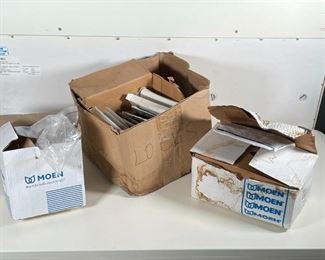 GROUP MISC. HOUSEHOLD HARDWARE | Including misc. hinges, 4 boxes of Baldwin classic knobs, interior latches, a Moen faucet in box, and another Moen box with fixtures 