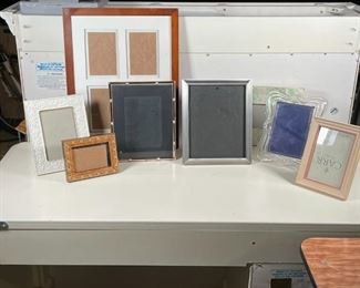 (8pc) PICTURE FRAMES | Including a four way frame (19 x 15 in.), and frames of glass, porcelain, wood, and other 