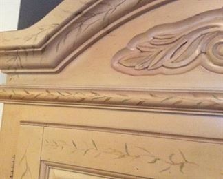 Light Wood Cabinet with flower stencils around the doors & top arch