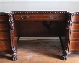 33 - Lloyd Buxton carved & inlaid mahogany desk With glass top Adorned with carved lion heads 31 x 78 x 25
