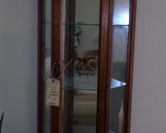 Lighted slim-case curio cabinet.