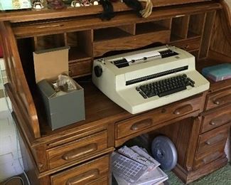 Roll top desk, IBM typewriter, tribal masks