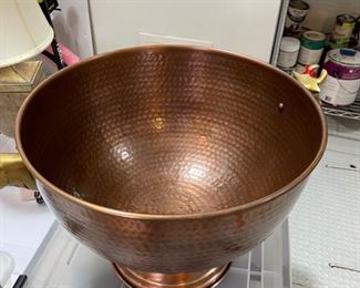 copper bowl for drinks has head of cows on each side