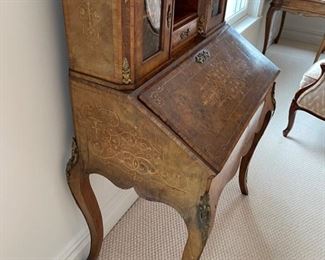 Slant Front Desk from 19th Century France with Center raised mirror flaked by compartments, Bronze Gallery and mounts, pigeonholed interior having four compartments with 3 drawers and leather writing area.  Bought from London and appraised at $8,000 in 2008. 60x100x18.