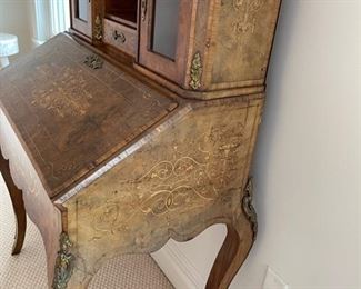 Slant Front Desk from 19th Century France with Center raised mirror flaked by compartments, Bronze Gallery and mounts, pigeonholed interior having four compartments with 3 drawers and leather writing area.  Bought from London and appraised at $8,000 in 2008. 60x100x18.