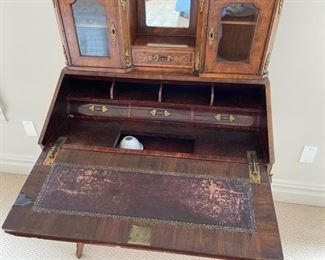 Slant Front Desk from 19th Century France with Center raised mirror flaked by compartments, Bronze Gallery and mounts, pigeonholed interior having four compartments with 3 drawers and leather writing area.  Bought from London and appraised at $8,000 in 2008. 60x100x18.