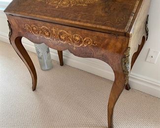 Slant Front Desk from 19th Century France with Center raised mirror flaked by compartments, Bronze Gallery and mounts, pigeonholed interior having four compartments with 3 drawers and leather writing area.  Bought from London and appraised at $8,000 in 2008. 60x100x18.