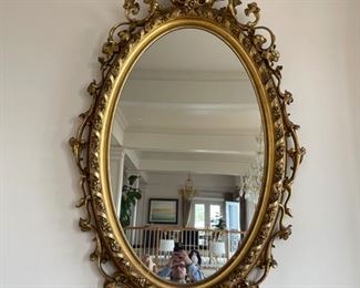 Large mirror 92 x 40 inches long Giltwood and Plaster oval wall mirror 19th Century elaborate scrollwork with garland designed bezel and pierced figural crest having a scrolled acanthus leaf network encircling the frame. Appraised at $16,000 in 2008. Mirror is from James S Earle Galleries