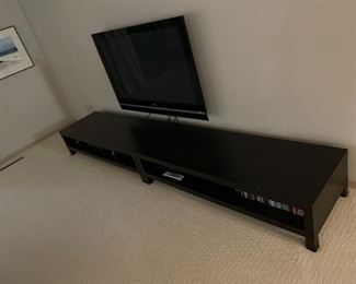 flat screen tv and long tables to store electronics, CDs, DVDs, etc.