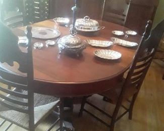 Empire Dining Table and 4 of the Antique Ladder Style chairs There are also 2 Arm chairs  Candlelabra   Plated old Serving Pieces