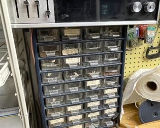 Storage cabinet filled with nuts, bolts, screws, nails, etc