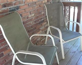 Two of four metal outdoor chairs