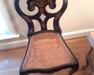 Lacquerware chair with gold ornamentathion and cane seat