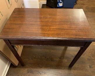 Solid mahogany table that opens up and comes with 3 leaves.    Has a 5th leg in a hidden compartment on the underside.   $200