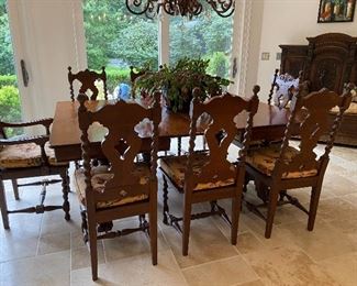 Dark Wooden Antique Table with 2 extensions and turned legs. 8 matching chairs with  new cushions