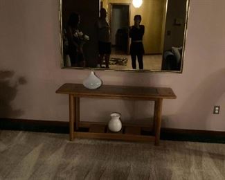 . . . a nice accent mirror above wall/sofa table with nice white accent vases