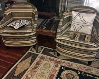 Contemporary upholstered fireside chair (sold separately). Area rug for sale.