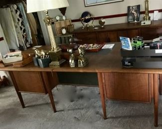 Mid-century walnut 6-drawer desk, 84"W x 40"D x 28"H.  Matching credenza in the background - 6 drawers and storage area with bi-fold doors,  78"W x 21.25"D x 28"H. Sold separately.