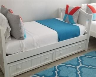 Trundle bed. Beds may be configured as bunks or as shown