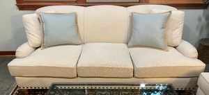 his Cambridge Collection sofa is upholstered in a luxurious ivory fabric accented with studded detailing.  The neutral fabric would match any home decor. This high quality, high end sofa measures 87x36x37 inches.  Sold in very good condition with no reserve. 