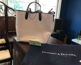 #30	Dooney and Bourke cream color pattern bag with blace accent and red lining , it has a wristlet and key chain 	 $50.00 	
