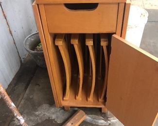A folding wooden table and 4 chair set storage