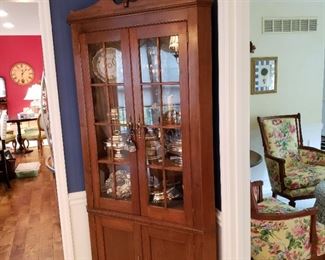 Mahogany corner cabinet with two glass doors above two cupboard doors