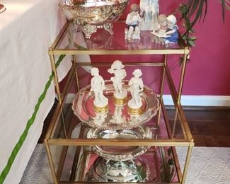 Pair of brass tone and glass step back end tables with Portugal and B & G porcelains and silverplate oval bowls