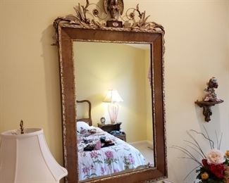 Walnut and gilt framed wall mirror with Eagle pediment approximately 28 ¼ inches wide by 50 inches high
