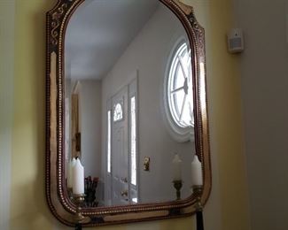 Arched top gilt decorated wall mirror approximately 27 inches tall by 24 inches wide