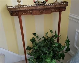 Marble top wall mounted console table with brass gallery top and ormolu decorated, approximately 26 inches wide by 8 ½ inches deep by 31 ½ high, reproduction Spainish