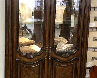 Bernhardt Tuscan style lighted display cabinet. Cherry finish. Arched beveled glass burled wood doors. Mirrored display. Glass shelves. Two dovetailed felt lined drawers over 4 clean as new drawers.