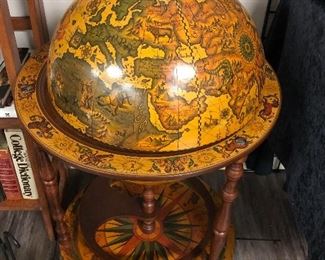 Classic old world globe drink cabinet. Swivel casters, bottle and glassware storage inside.
