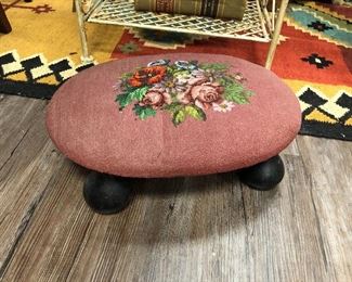 Antique oval foot rest. Hand stitched and beaded needlepoint, maple base. Circa 1915.