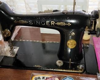 Antique Singer sewing machine in cabinet