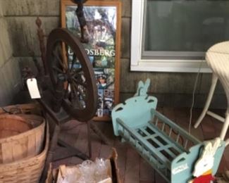 Spinning wheel, old baskets, cradle