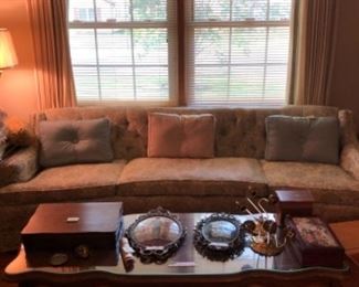 Couch, coffee table and collectibles
