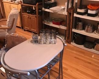Bistro set with a complete Silver trimmed glass set with coasters and rack! Microwave atop a  nice rolling cart! Small appliances in background!