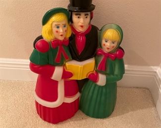 $65 - 18" carolers look like just spotted the neighborhood dog and are huddled together for saftey - maybe keep this one inside, perhaps on a window sill.
