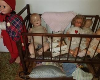 dolls in antique crib