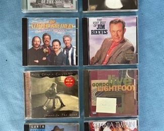 Eight country CDs featuring George Jones, Mary Chaplin Carpenter, Statlers, Reeves, Lightfoot, Garth, and Shania