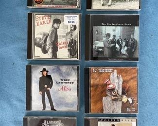 Eight country CDs featuring Outlaws, Tracy Lawrence, Alabama, and Collin Raye