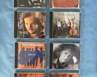 Eight country CDs featuring Vince Gill, Travis Tritt, Reba, and more