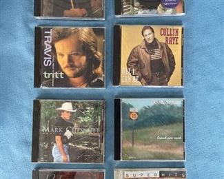 Eight country CDs featuring J M Montgomery, Tim McGraw, Tritt, Raye, Mark Chesnutt, Reba, and Willie