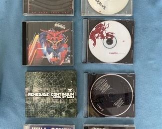 Nine CDs featuring rap, metal, and electronics